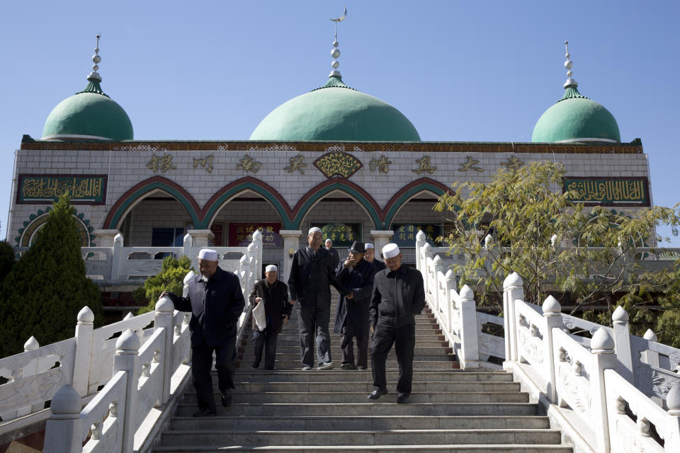 FILE - Hui ethnic minority men leave a mosque after prayers in Yinchuan in northwestern China's Ningxia Hui autonomous region on Thursday, Oct. 8, 2015. The Chinese government has expanded its campaign of shuttering mosques to provinces other than Xinjiang, where Beijing has for years been blamed of persecuting Muslim minorities, according to a report released Wednesday by Human Rights Watch. (AP Photo/Ng Han Guan, File)