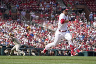 St. Louis Cardinals' Nolan Arenado runs to first for a single as San Diego Padres relief pitcher Pierce Johnson, left, fails to throw out Arenado at first during the fifth inning of a baseball game Sunday, Sept. 19, 2021, in St. Louis. (AP Photo/Jeff Roberson)