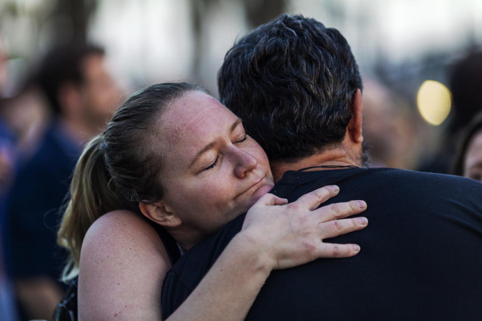 People hug during a public vigil for the 34 victims of the fire aboard the 75-foot commercial diving boat Conception, which burned and sank off the coast of Santa Cruz Island in Santa Monica, California.