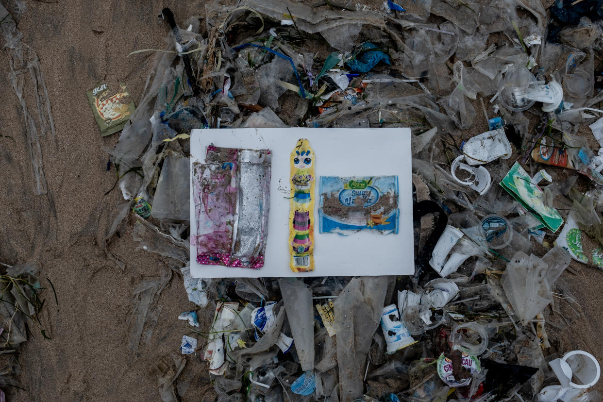 KEDONGANAN, BALI, INDONESIA - JANUARY 30: Plastic washing liquid, ice cream and breed packets which were found washed ashore on Kedonganan Beach on January 30, 2021 in Kedonganan, Bali, Indonesia. About eight million metric tons of plastics are thrown into the ocean every year, according to studies published in scientific journals - by 2050, it is estimated that the weight of plastics in the oceans will exceed the weight of all marine life, and microplastics are already being ingested by fish and starting to appear in the human food chain. Huge concentrations of plastic are carried by currents to form massive collections of waste, such as the 