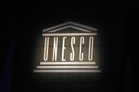 FILE - The logo of the United Nations Educational, Scientific and Cultural Organisation (UNESCO) is seen during the 39th session of the General Conference at the UNESCO headquarters, Oct.31 2017 in Paris. The United States is ready to rejoin the U.N. cultural and scientific agency UNESCO – and pay more than $600 million in back dues -- after a decade-long dispute sparked by the organization's move to include Palestine as a member. (AP Photo/Francois Mori, File)