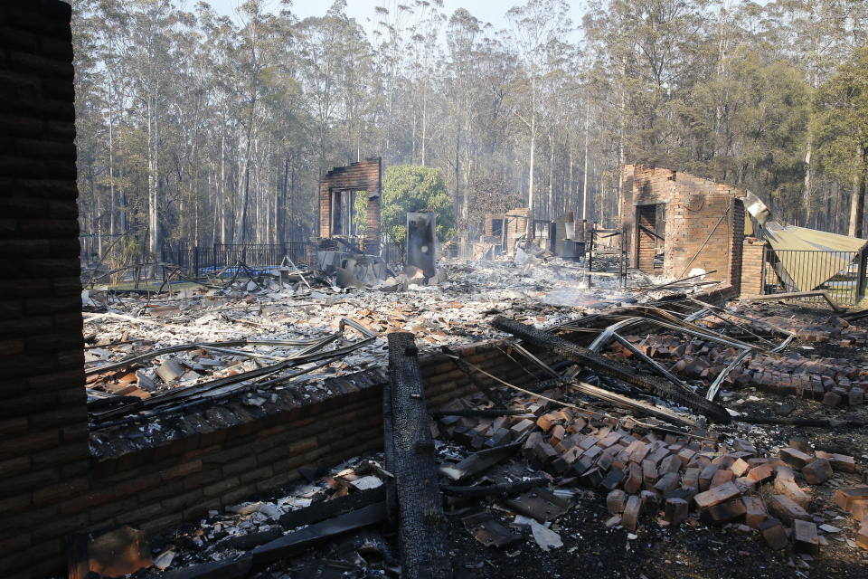 The remains of the residence at Four Paws boarding kennels smoulders along the Pacific Highway south of  Taree on Saturday. Source: AAP Image / Darren Pateman.