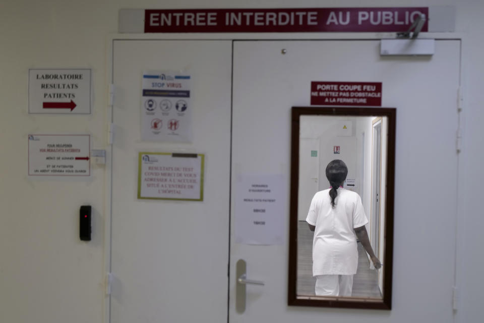 Health lab technician walks in a zone forbidden to public to process test for COVID-19 at the Hospital of Argenteuil, north of Paris, Friday Sept. 25, 2020. France's health agency announced Thursday evening that the country has had 52 new deaths and has detected over 16,000 new cases of coronavirus in 24 hours. (AP Photo/Francois Mori)