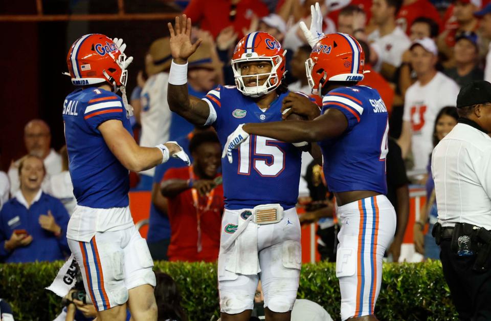 Florida quarterback Anthony Richardson (15) is congratulated  by wide receiver Justin Shorter (4) and wide receiver Ricky Pearsall after he scored a touchdown against Utah during the second quarter at Steve Spurrier-Florida Field.