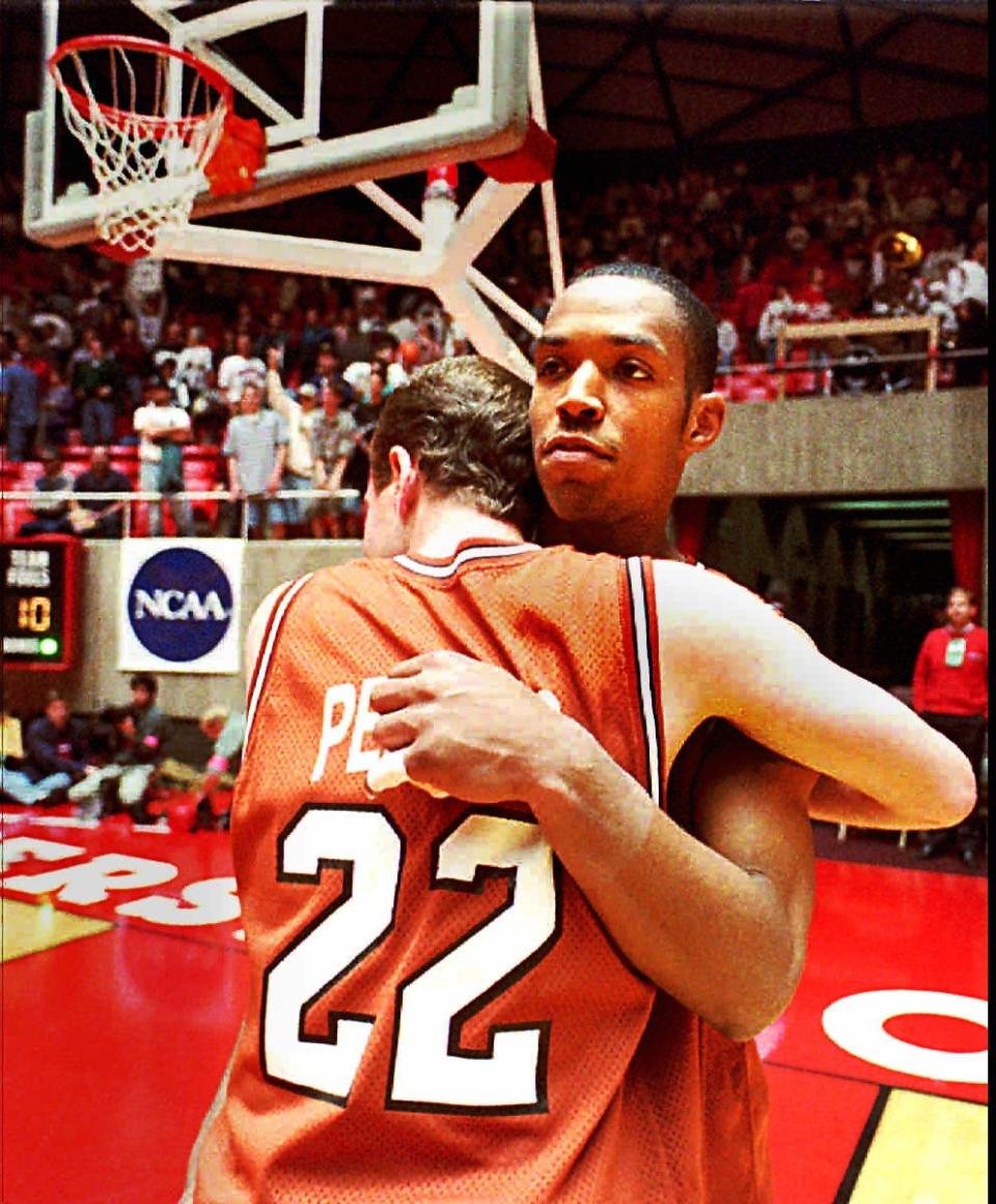 UT seniors Terrence Rencher and Tommy Penders (22) hug one another under the basket after their season came to a end by losing to Maryland in the NCAA Tournament in Salt Lake City on March 18, 1995.