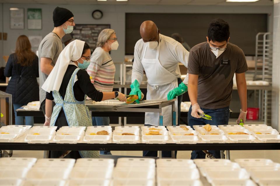 Volunteers prepare lunches for individuals at risk of homelessness at Eva's Village in Paterson, N.J. on Friday Jan. 28, 2022. 