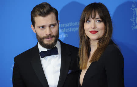 Actors Dakota Johnson and Jamie Dornan (L) arrive for the screening of the movie 'Fifty Shades of Grey' at the 65th Berlinale International Film Festival in Berlin February 11, 2015. REUTERS/Stefanie Loos