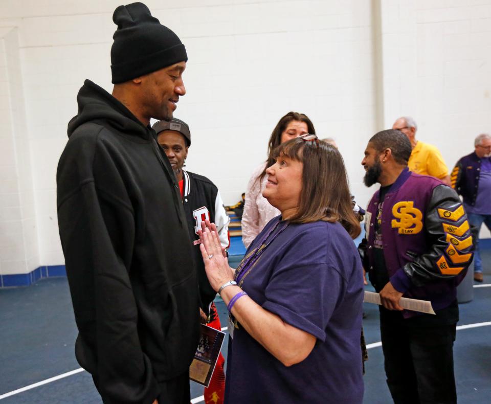 Former Clay basketball player Lee Nailon, left, talks with current Clay teacher Connie Benson during an alumni event Friday, Feb. 16, 2024, at Clay High School in South Bend.