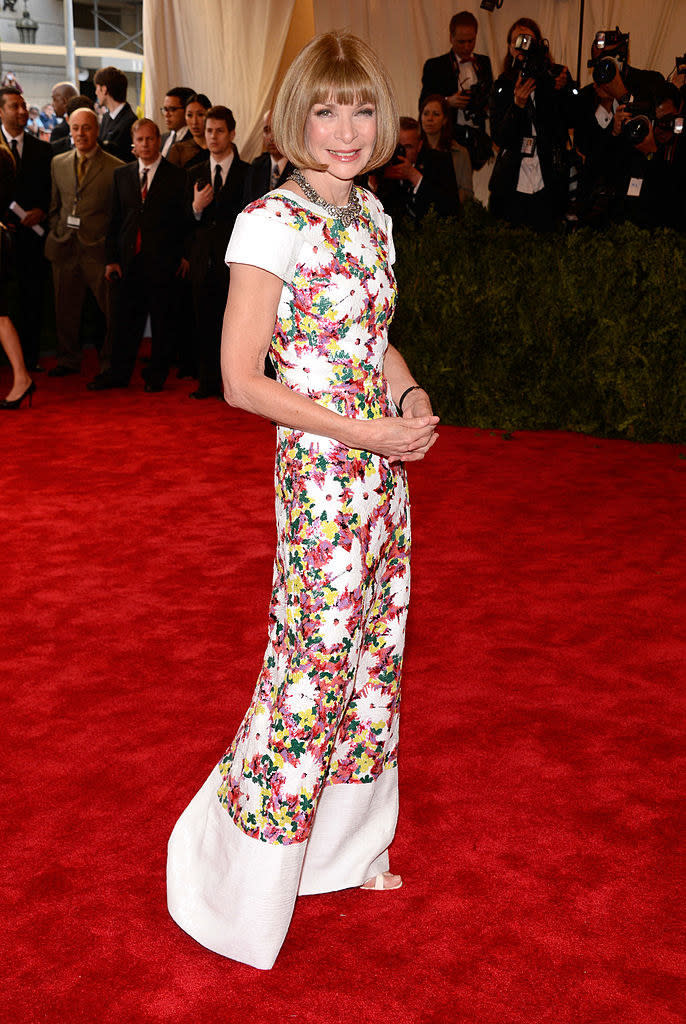 Anna wearing a white dress with a colorful floral design on it