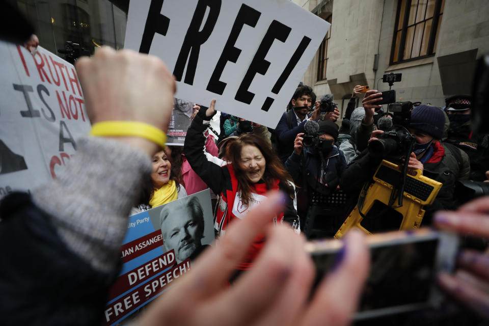 Julian Assange supporters celebrate after a ruling that he cannot be extradited to the United States, outside the Old Bailey in London, Monday, Jan. 4, 2021. A British judge has rejected the United States' request to extradite WikiLeaks founder Julian Assange to face espionage charges, saying it would be "oppressive" because of his mental health. District Judge Vanessa Baraitser said Assange was likely to commit suicide if sent to the U.S. The U.S. government said it would appeal the decision. (AP Photo/Frank Augstein)