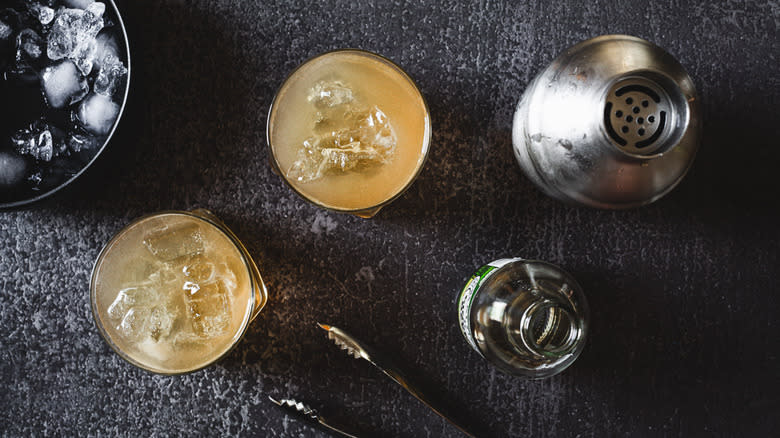 two cocktail glasses with ginger beer bottle