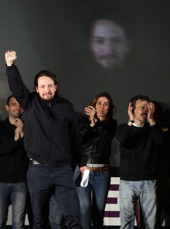 Anti-austerity party Podemos' leader Pablo Iglesias (L) raises his fist next to candidate for Madrid's regional presidency Jose Manuel Lopez (R)