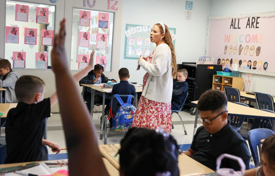 Palm Pointe K-8 teacher Katlyn McCue leads a reading lesson in her 3rd-grade classroom, Tuesday, Feb. 6, 2024, in Port St. Lucie. McCue is a recipient of St. Lucie Public School's Promise is a Promise program. The program guarantees participating St. Lucie County students a teaching job in the district after graduation. She is a recipient of the county's Outstanding First Year Teacher award.