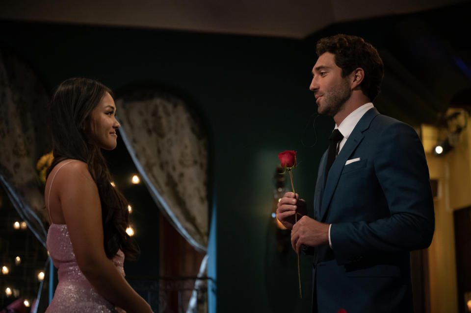 Joey handing Jenn Tran a rose during a rose ceremony. Tran was announced as the new Bachelorette.