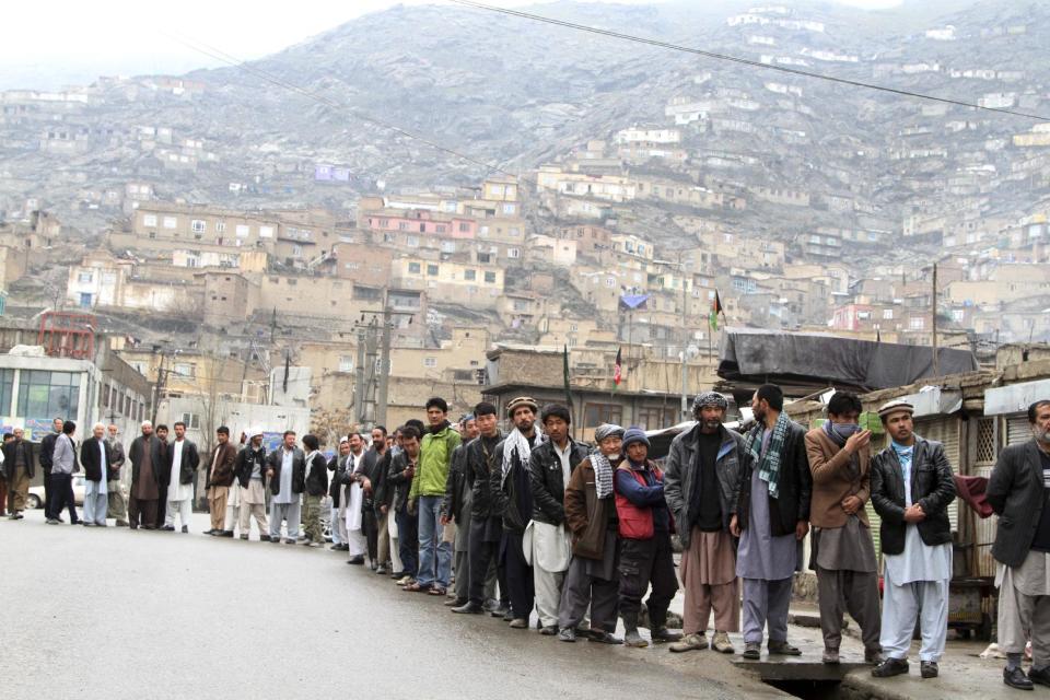 Afghan men line up outside a polling station to cast their ballots, in Kabul, Afghanistan, Saturday, April 5, 2014. (AP Photo/Rahmatullah Nikzad)