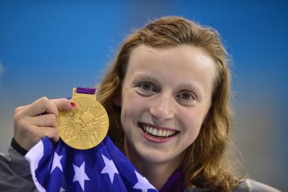 Katie Ledecky poses on the Olympic podium in 2012 after winning gold in the women's 800m freestyle. (AFP)