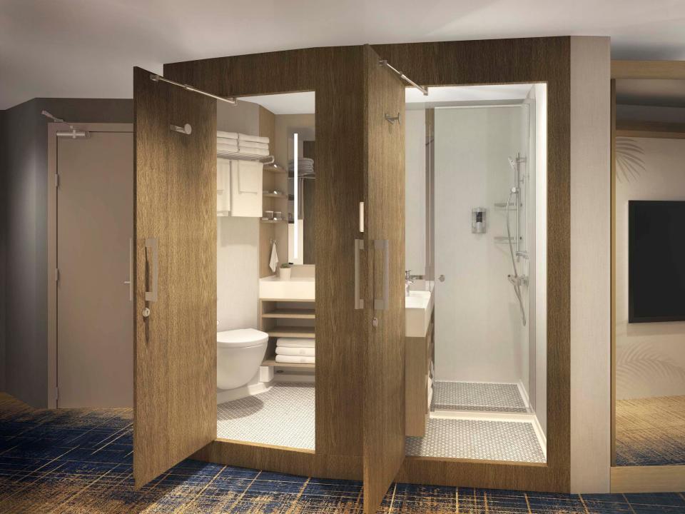 A rendering of the two bathrooms and a bed in Royal Caribbean's upcoming Icon of the Seas cruise ship