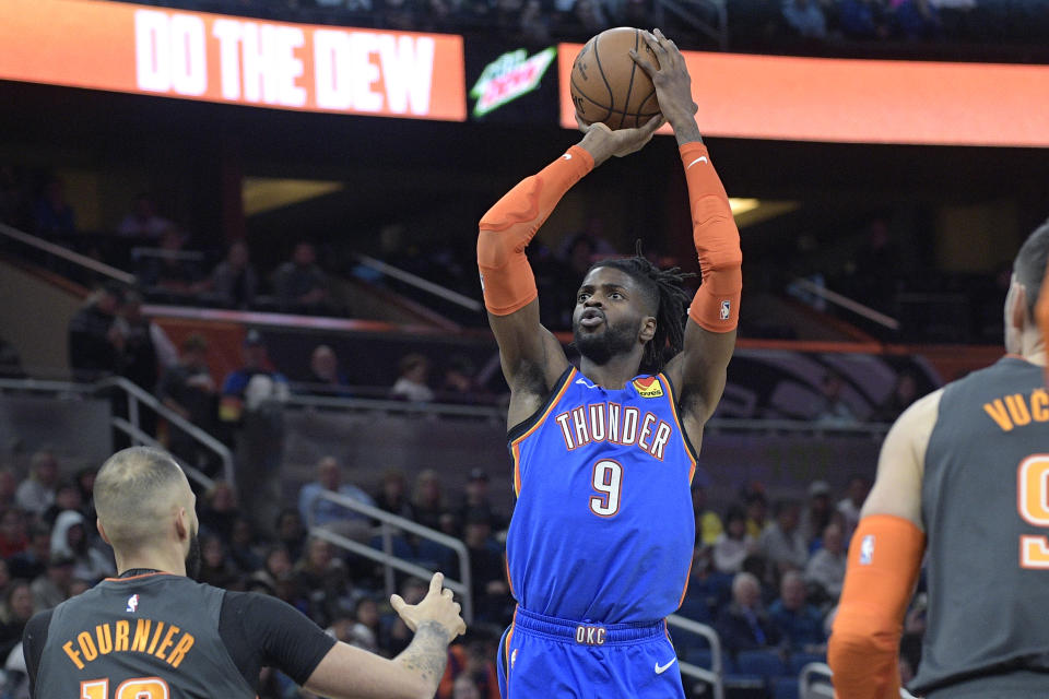 Oklahoma City Thunder center Nerlens Noel (9) goes up for a shot between Orlando Magic guard Evan Fournier, left, and center Nikola Vucevic (9), right, during the first half of an NBA basketball game Wednesday, Jan. 22, 2020, in Orlando, Fla. (AP Photo/Phelan M. Ebenhack)