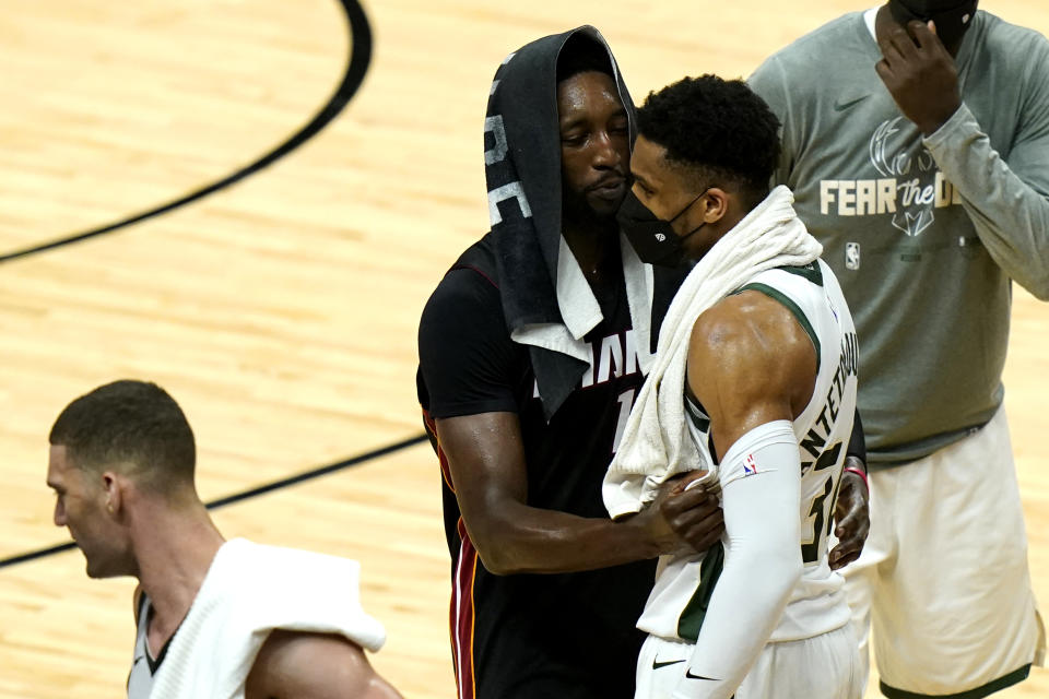 Miami Heat center Bam Adebayo, center, talks with Milwaukee Bucks forward Giannis Antetokounmpo after Game 4 of an NBA basketball first-round playoff series, Saturday, May 29, 2021, in Miami. The Bucks won 120-103. (AP Photo/Lynne Sladky)