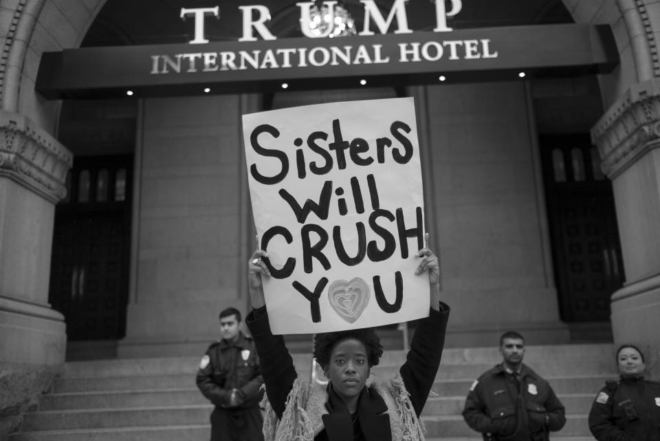 <p>A protestor holds up a sign in front of the Trump International Hotel during the Women’s March on Washington the day after Inauguration Day in Washington on Jan. 21, 2017. (Photograph by Tomas van Houtryve/VII) </p>