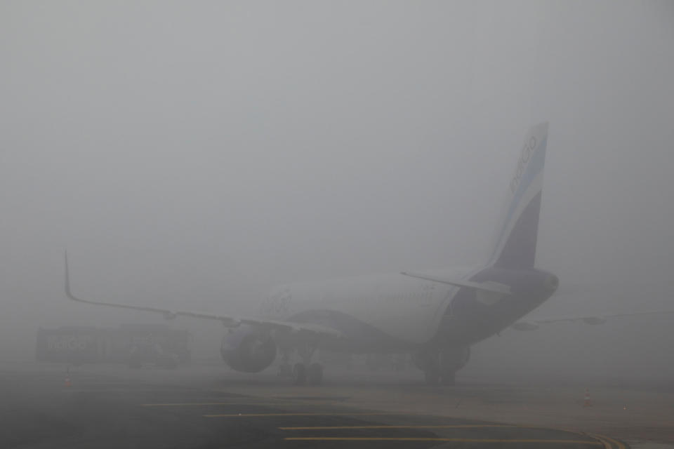 An IndiGo Airlines aircraft is seen shrouded in fog