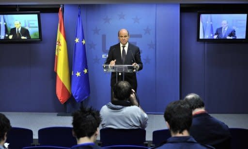 Spanish Finance Minister Luis De Guindos gives a press conference on Tuesday following an ECOFIN meeting. European Union finance ministers bought Spain more time to revive its sickly economy on Tuesday, offering 30 billion euros to save the country's banks and protect Europe from more debt contagion