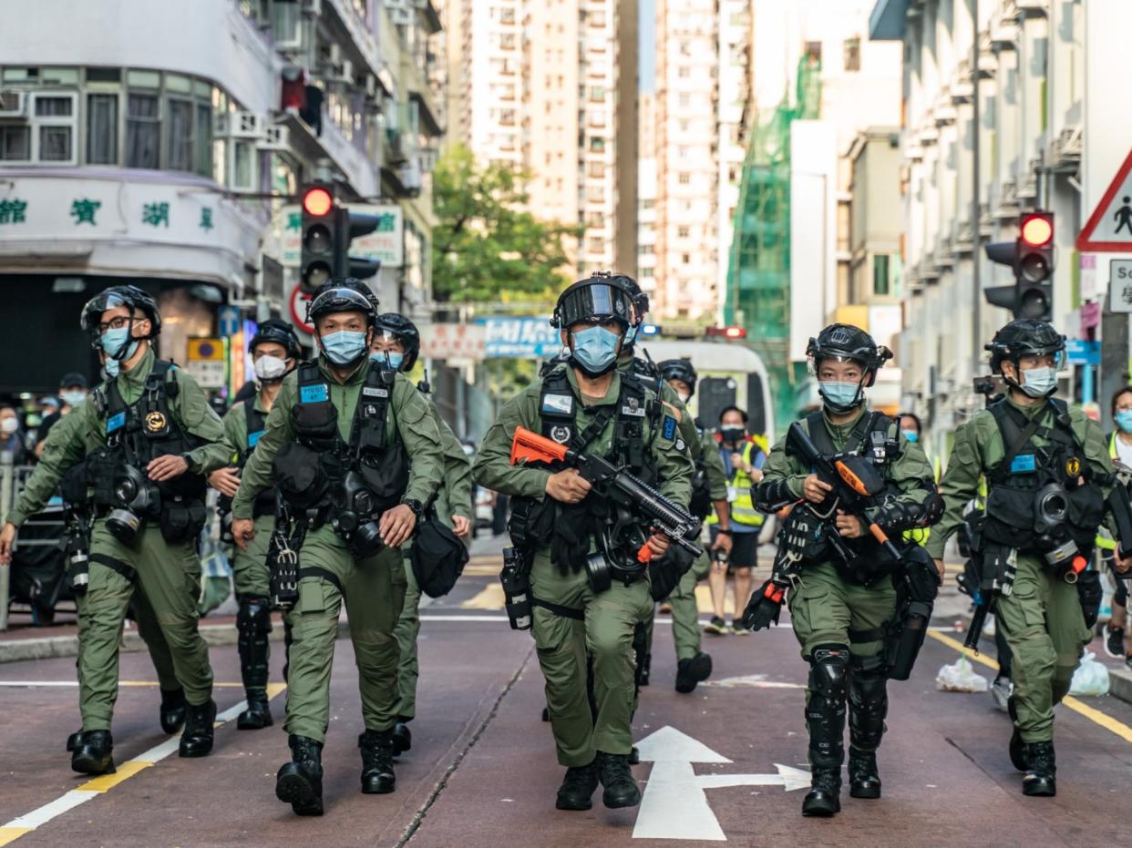 Riot police charge on a street during an anti-government protest in Hong Kong, Chin (Getty)