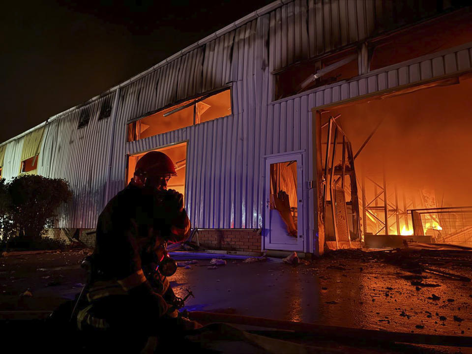 In this photo provided by the Ukrainian Emergency Service, emergency service personnel try to extinguish a fire following a Russian attack in Odesa, Ukraine, Wednesday, May 1, 2024. (Ukrainian Emergency Service via AP)