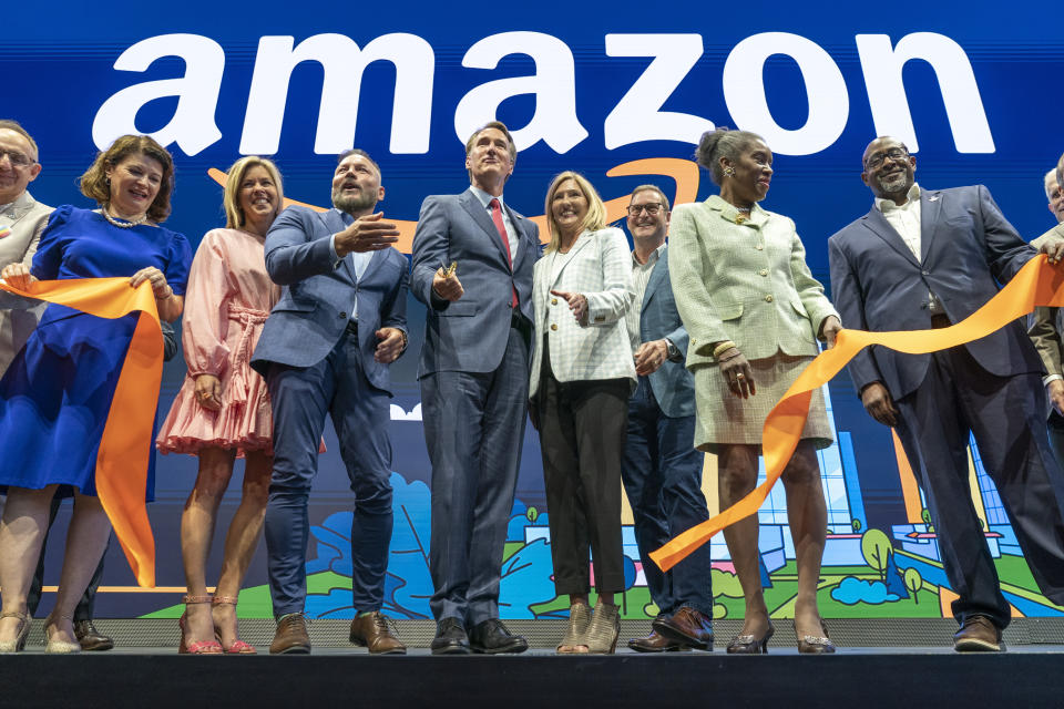 Virginia Gov. Glenn Youngkin, center left, with Holly Sullivan, vice president of economic development at Amazon, center right, cut the ribbon during Amazon's HQ2 grand opening ceremony. From right: Christian Dorsey, chair of the Arlington County Board of Directors, Lieutenant Gov. of Virginia Winsome Earle-Sears, John Schoettler, vice president of global real estate and facilities at Amazon, Holly Sullivan, Gov. Glenn Youngkin, Brian Huseman, vice president of public policy and community engagement at Amazon, and Youngkin's spouse, Suzanne Youngkin. 