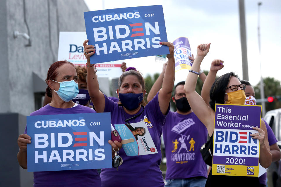 MIAMI SPRINGS, FLORIDA - OCTOBER 11: People show their support as they participate in a caravan for Democratic presidential nominee Joe Biden event on October 11, 2020 in Miami Springs, Florida. The caravan was held by people from the South Florida AFL-CIO, including LIUNA, IBEW, IUPAT, SFBCTC, SEIU, TWU Local 291, United Teachers of Dade, AFSCME, American Postal Workers Union and others, as part of a countywide caravan in support of Joe Biden.  (Photo by Joe Raedle/Getty Images)