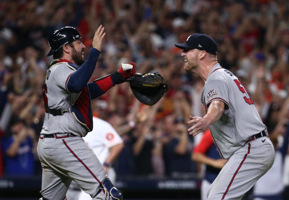 Atlanta Braves catcher Travis d'Arnaud and reliever Will Smith celebrate after the final out of Game 6 of last year's World Series.