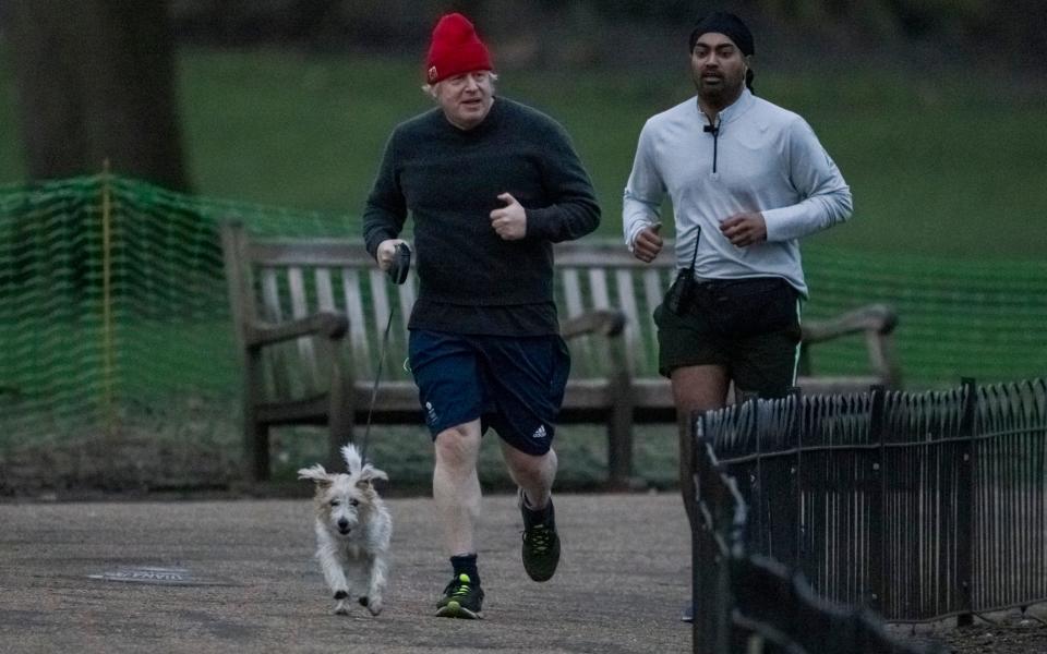 Boris Johnson running in Westminster with his dog Dilyn - Peter Macdiarmid/LNP