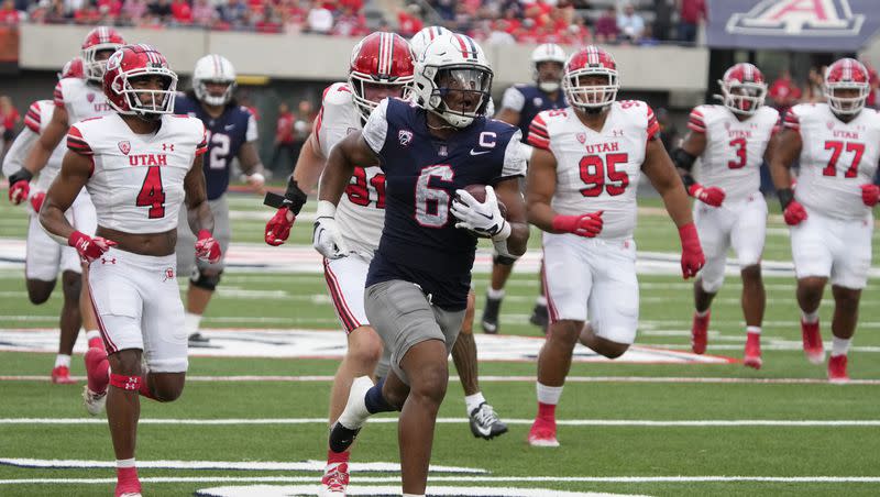 Arizona running back Michael Wiley (6) scores a touchdown against Utah during the first half of an NCAA college football game, Saturday, Nov. 18, 2023, in Tucson, Ariz. (AP Photo/Rick Scuteri)