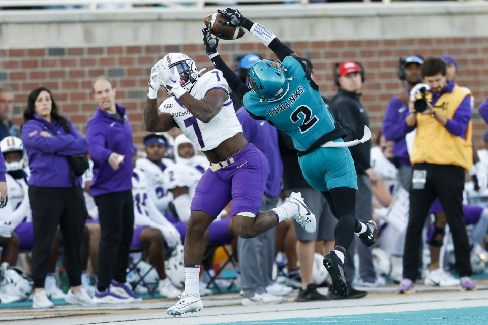Coastal Carolina cornerback Courtney Eubanks (2) intercepts a pass intended for James Madison running back Ty Son Lawton during the first half of an NCAA college football game in Conway, N.C., Saturday, Nov. 25, 2023. (AP Photo/Nell Redmond)