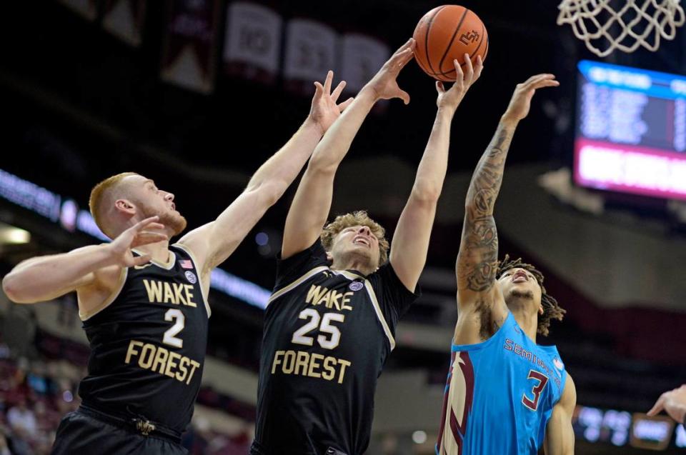 Jan 9, 2024; Tallahassee, Florida, USA; Wake Forest Demon Deacons forward Zach Keller (25), guard Cameron Hildreth (2) and Florida State Seminoles guard Cam Corhen (3) battle for a rebound during the first half at Donald L. Tucker Center.