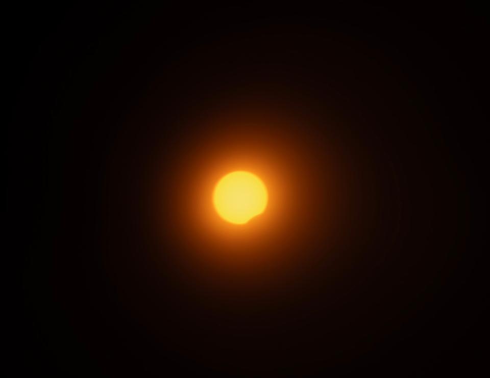 The 2024 solar eclipse as the moon moves in front of the sun seen from South Burlington, Vermont, on Monday, April 8, 2024.