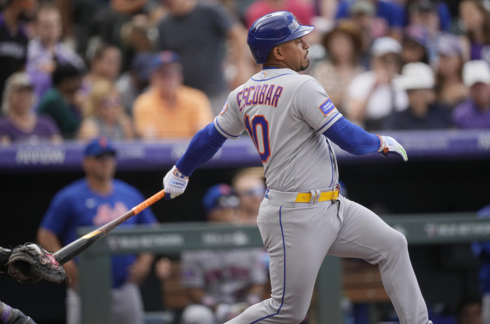 New York Mets' Eduardo Escobar follows the flight of his RBI-single off Colorado Rockies starting pitcher Austin Gomber in the fourth inning of a baseball game , Sunday, May 28, 2023, in Denver. (AP Photo/David Zalubowski)