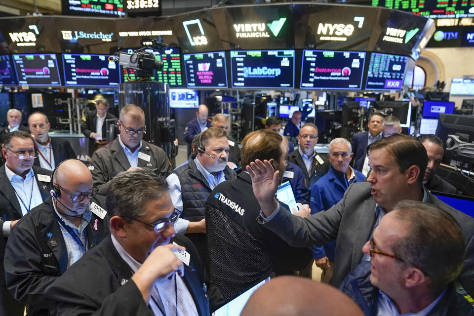 Traders gather around a post as Twitter shares resume trading on the floor at the New York Stock Exchange in New York, Tuesday, Oct. 4, 2022. (AP Photo/Seth Wenig)