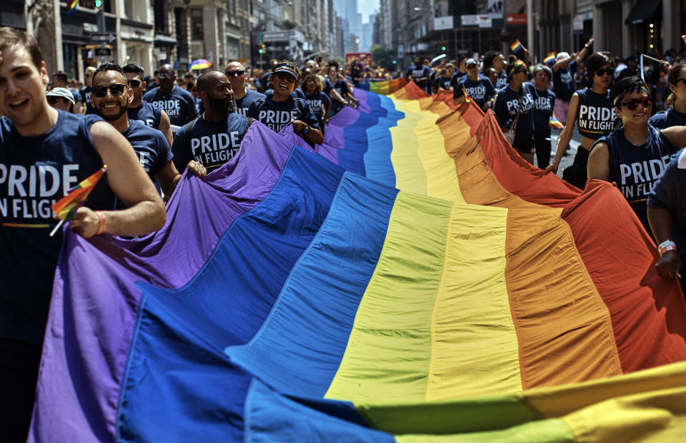 FILE - Reveler carry a LTBGQ flag along Fifth Avenue during the New York City Pride Parade on Sunday, June 24, 2018, in New York. Parades celebrating LGBTQ pride kick off in some of America's biggest cities Sunday amid new fears about the potential erosion of freedoms won through decades of activism. The annual marches in New York, San Francisco, Chicago and elsewhere take place just two days after one conservative justice on the Supreme Court signaled, in a ruling on abortion, that the court should reconsider the right to same-sex marriage recognized in 2015. (AP Photo/Andres Kudacki, File)