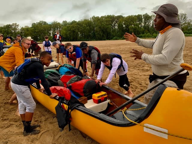 Former New York Giants defensive back Mark People's is a long-time member of the Quapaw team. Here, he gives instructions to a group before embarking on a expedition.