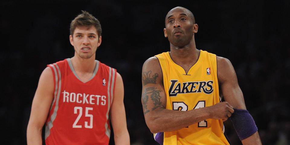 Chandler Parsons stands next to Kobe Bryant on the court during a game in 2012.