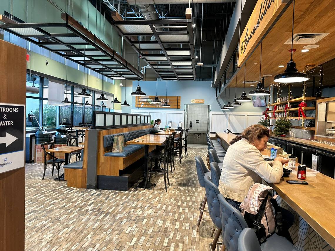 Teresa Garcia eats at the customer El Bocadilla bar and cafe area at the Whole Foods Market in Pinecrest on a quiet weekday afternoon on Dec. 7, 2023.