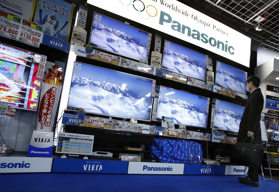 A shopper looks at Panasonic's flat-panel televisions at an electronics retail store in Tokyo Tuesday, Feb. 4, 2014. Panasonic Corp. says profit rose 20 percent in the October-December quarter as growth in businesses such as smart home systems offset its long struggling TV and appliance divisions. The Japanese manufacturing giant reported net income of 73.7 billion yen ($728 million), up from 61.3 billion yen a year earlier. (AP Photo/Shizuo Kambayashi)