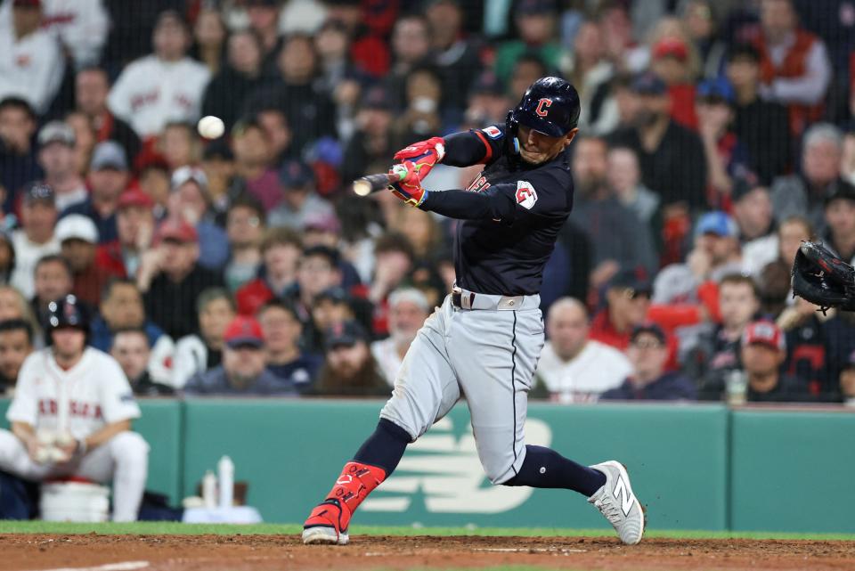 Guardians second baseman Andres Gimenez hits an RBI single during the ninth inning against the Red Sox at Fenway Park, April 16, 2024, in Boston.