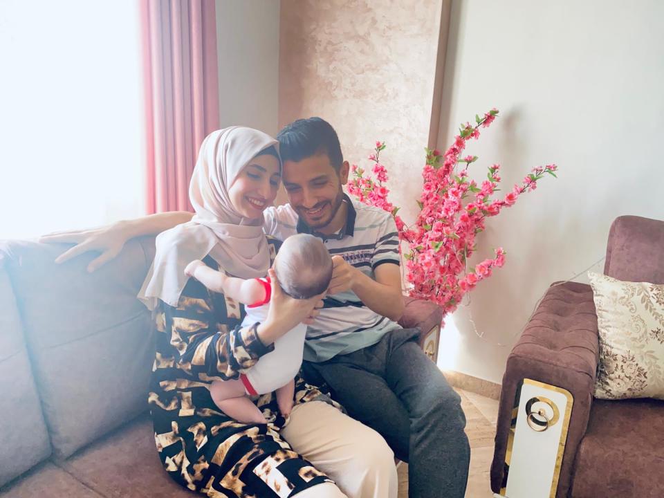 Issam Adwan and his wife hold their baby, Sara, in Gaza in July 2022.