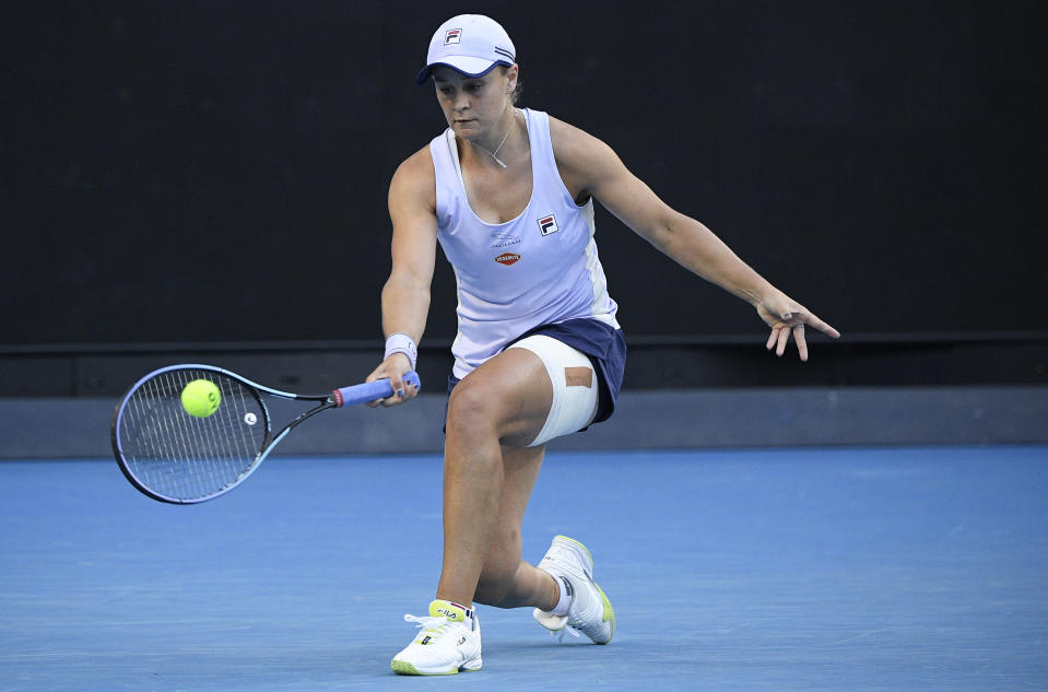 Australia's Ash Barty hits a forehand return to Russia's Ekaterina Alexandrova during their third round match at the Australian Open tennis championship in Melbourne, Australia, Saturday, Feb. 13, 2021.(AP Photo/Andy Brownbill)