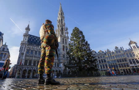 A Belgian soldier patrols in Brussels' Grand Place as police searched the area during a continued high level of security following the recent deadly Paris attacks, Belgium, November 23, 2015. REUTERS/Yves Herman