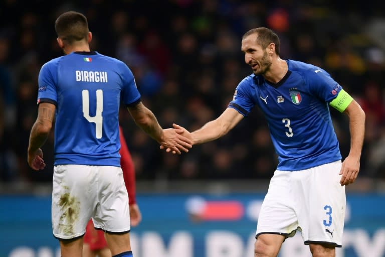 Italy captain Giorgio Chiellini (R) earned his 100th cap