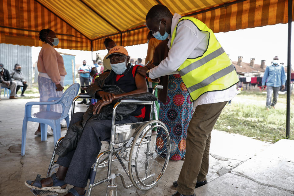 A Kenyan man receives a dose of the AstraZeneca coronavirus vaccine donated by Britain, at the Makongeni Estate in Nairobi, Kenya Saturday, Aug. 14, 2021. In late June, the international system for sharing coronavirus vaccines sent about 530,000 doses to Britain – more than double the amount sent that month to the entire continent of Africa. It was the latest example of how a system that was supposed to guarantee low and middle-income countries vaccines is failing, leaving them at the mercy of haphazard donations from rich countries. (AP Photo/Brian Inganga)