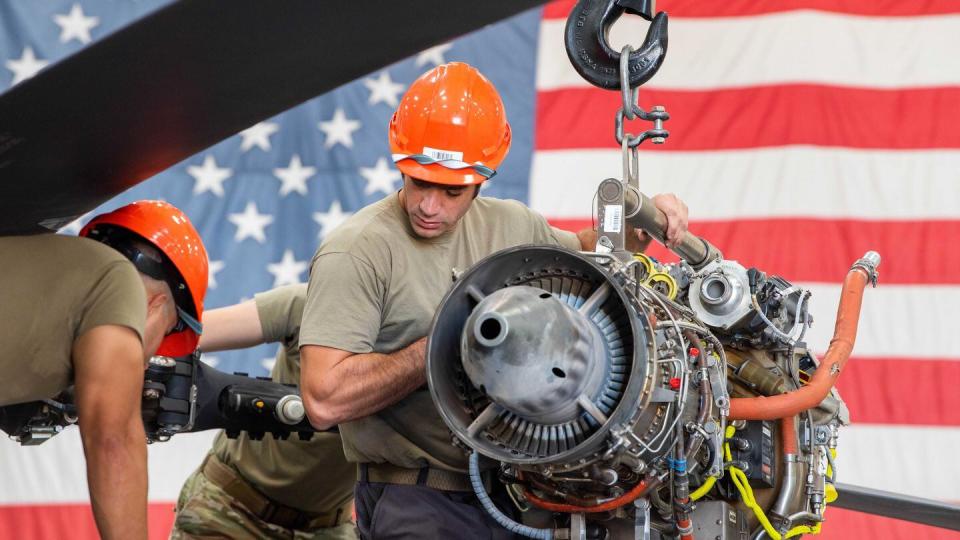 Staff Sgt. Manuel Castaneda and Tech. Sgt. Anthony Staley, 943rd Maintenance Squadron crew chiefs, replace an HH-60G Pave Hawk engine Aug. 2 at Davis-Monthan Air Force Base, Ariz. (Senior Airman Quion Lowe/Air Force)